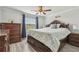 Charming bedroom featuring a wooden bed frame, ceiling fan, and dresser with a window view at 11602 Sunburst Marble Rd, Riverview, FL 33579