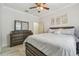 Spacious bedroom with crown molding, marble floors, ceiling fan, and dark wood furnishings at 11602 Sunburst Marble Rd, Riverview, FL 33579