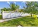 A view of the yard of the home showing the lush grass and white vinyl fence at 11602 Sunburst Marble Rd, Riverview, FL 33579