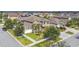 Inviting two-story home featuring lush landscaping, a manicured lawn, and a charming front porch at 11602 Sunburst Marble Rd, Riverview, FL 33579