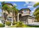 Stunning exterior showcasing a two-story home, manicured lawn, and lush tropical landscaping at 11602 Sunburst Marble Rd, Riverview, FL 33579