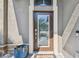 Charming front door with glass panes, stylish hardware, and a 'Welcome as Guests' doormat at 11602 Sunburst Marble Rd, Riverview, FL 33579