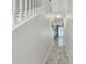 A long hallway with marble floors leading to a living area with blue curtains at 11602 Sunburst Marble Rd, Riverview, FL 33579