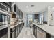 Modern kitchen featuring sleek black cabinets, stainless steel appliances and decorative backsplash at 11602 Sunburst Marble Rd, Riverview, FL 33579