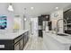 Bright kitchen featuring white marble floors, stainless steel appliances, and pendant lighting over the island at 11602 Sunburst Marble Rd, Riverview, FL 33579