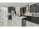 Spacious kitchen featuring granite counters, stainless steel appliances, and sleek dark cabinetry at 11602 Sunburst Marble Rd, Riverview, FL 33579