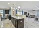 Stylish kitchen with island seating and an adjacent open floor plan living area and a view to the pool at 11602 Sunburst Marble Rd, Riverview, FL 33579