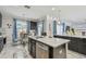 Modern kitchen featuring an island, stainless steel appliances and an adjacent breakfast nook with lots of light at 11602 Sunburst Marble Rd, Riverview, FL 33579