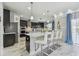 Modern kitchen with stainless steel appliances, black cabinets, stone accent wall and stylish bar stool seating at 11602 Sunburst Marble Rd, Riverview, FL 33579