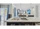 Bright open kitchen with stone accent wall, a large island with sink, and stainless steel appliances at 11602 Sunburst Marble Rd, Riverview, FL 33579