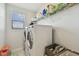 Well-equipped laundry room with a front load washer and dryer, shelving and natural light at 11602 Sunburst Marble Rd, Riverview, FL 33579