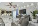 Modern living room features a decorative stone wall, recessed lighting, marble floors, and flows into the open kitchen at 11602 Sunburst Marble Rd, Riverview, FL 33579