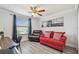 Bright room featuring a sofa, and chair, complemented by a ceiling fan and a window view at 11602 Sunburst Marble Rd, Riverview, FL 33579
