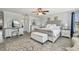 Bright bedroom showcases a tufted bed, decorative rug, and white furniture, offering a serene and inviting space at 11602 Sunburst Marble Rd, Riverview, FL 33579