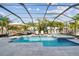 Stunning screened pool featuring a lounge area, spa, and serene tropical landscaping for ultimate relaxation at 11602 Sunburst Marble Rd, Riverview, FL 33579