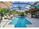 Beautiful screened pool with a swim-up bar, luxurious tile accents, and ample room for relaxation and entertainment at 11602 Sunburst Marble Rd, Riverview, FL 33579