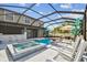Backyard pool and spa, outdoor seating, and enclosed lanai provide an ideal space for outdoor living at 11602 Sunburst Marble Rd, Riverview, FL 33579