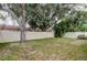 Spacious backyard features a large tree, white vinyl fence and plenty of room for recreation at 11641 Branch Mooring Dr, Tampa, FL 33635