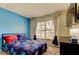 bedroom features a blue accent wall, comfortable carpet and large sunny window at 11641 Branch Mooring Dr, Tampa, FL 33635