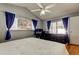 Bedroom with a ceiling fan, neutral walls, and natural light at 11641 Branch Mooring Dr, Tampa, FL 33635