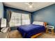 Cozy bedroom with blue walls, natural light, and ceiling fan at 11641 Branch Mooring Dr, Tampa, FL 33635