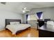 Well-lit bedroom boasts a ceiling fan, wood floors, and a dedicated workspace with a desk at 11641 Branch Mooring Dr, Tampa, FL 33635