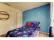 bedroom features a blue accent wall and a large window providing natural light at 11641 Branch Mooring Dr, Tampa, FL 33635