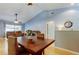 Open-concept dining area with hardwood flooring, connecting to the living room and kitchen at 11641 Branch Mooring Dr, Tampa, FL 33635