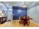 Cozy dining area with a stylish light fixture and a blue accent wall at 11641 Branch Mooring Dr, Tampa, FL 33635