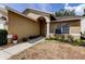 Charming single-story home featuring a welcoming front entrance with an arched entryway and well-maintained landscaping at 11641 Branch Mooring Dr, Tampa, FL 33635