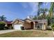 Inviting single-story home featuring a two-car garage, landscaped front yard, and neutral stucco exterior at 11641 Branch Mooring Dr, Tampa, FL 33635