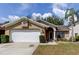Charming single-story home with a well-manicured lawn and attached two-car garage at 11641 Branch Mooring Dr, Tampa, FL 33635