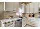 Well-lit kitchen showcasing white cabinets, stainless steel appliances, and quartz countertops at 11641 Branch Mooring Dr, Tampa, FL 33635