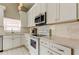 Updated kitchen with white cabinets, modern appliances, and tile floors at 11641 Branch Mooring Dr, Tampa, FL 33635