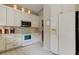 Well-equipped kitchen with white appliances, stylish cabinets, and bright lighting at 11641 Branch Mooring Dr, Tampa, FL 33635
