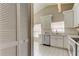 Kitchen featuring white cabinets, stainless steel dishwasher and tile floors at 11641 Branch Mooring Dr, Tampa, FL 33635