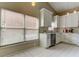 Spacious kitchen featuring white tile floors, ample natural light, and plenty of cabinet space at 11641 Branch Mooring Dr, Tampa, FL 33635