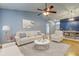 Bright living room featuring a vaulted ceiling, ceiling fan, and a dining area at 11641 Branch Mooring Dr, Tampa, FL 33635