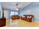 Inviting living room featuring comfortable brown sofas, a ceiling fan, and natural light at 11641 Branch Mooring Dr, Tampa, FL 33635