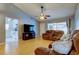 Comfortable living room featuring hardwood floors, a ceiling fan, and view to kitchen at 11641 Branch Mooring Dr, Tampa, FL 33635