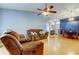 Inviting living area with hardwood flooring, ceiling fan, and comfortable seating arrangement at 11641 Branch Mooring Dr, Tampa, FL 33635