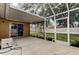 Enclosed patio with outdoor access to backyard with beautiful, green space at 11641 Branch Mooring Dr, Tampa, FL 33635