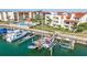 An aerial view of waterfront condos with private boat docks, a pool, and lush landscaping at 120 1St E St # 109, Tierra Verde, FL 33715