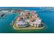 Aerial view showcases waterfront condos, a marina, a pool, and lush landscaping by the bay at 120 1St E St # 109, Tierra Verde, FL 33715