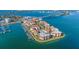 Aerial view of the waterfront community with a bridge in the background, featuring a marina and pool at 120 1St E St # 109, Tierra Verde, FL 33715