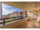 Balcony features a hanging chair, greenery, and views of building and landscaped lawn area at 120 1St E St # 109, Tierra Verde, FL 33715