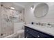 Modern bathroom with marble shower, shiplap wall, and navy blue vanity at 120 1St E St # 109, Tierra Verde, FL 33715
