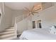Spacious bedroom featuring a large ceiling fan, two-story ceilings, stairs to loft, and neutral paint at 120 1St E St # 109, Tierra Verde, FL 33715