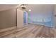 Bonus room featuring luxury vinyl plank flooring, barn door to storage space, and neutral paint at 120 1St E St # 109, Tierra Verde, FL 33715