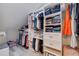 Organized walk in closet with custom shelving and drawer storage at 120 1St E St # 109, Tierra Verde, FL 33715